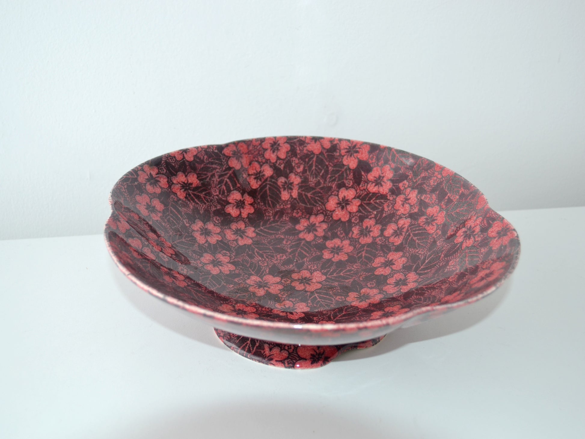 Top view of Royal Winton Grimwades chintz bowl showing all-over dark burgundy and pink floral chintz pattern, circa 1930s