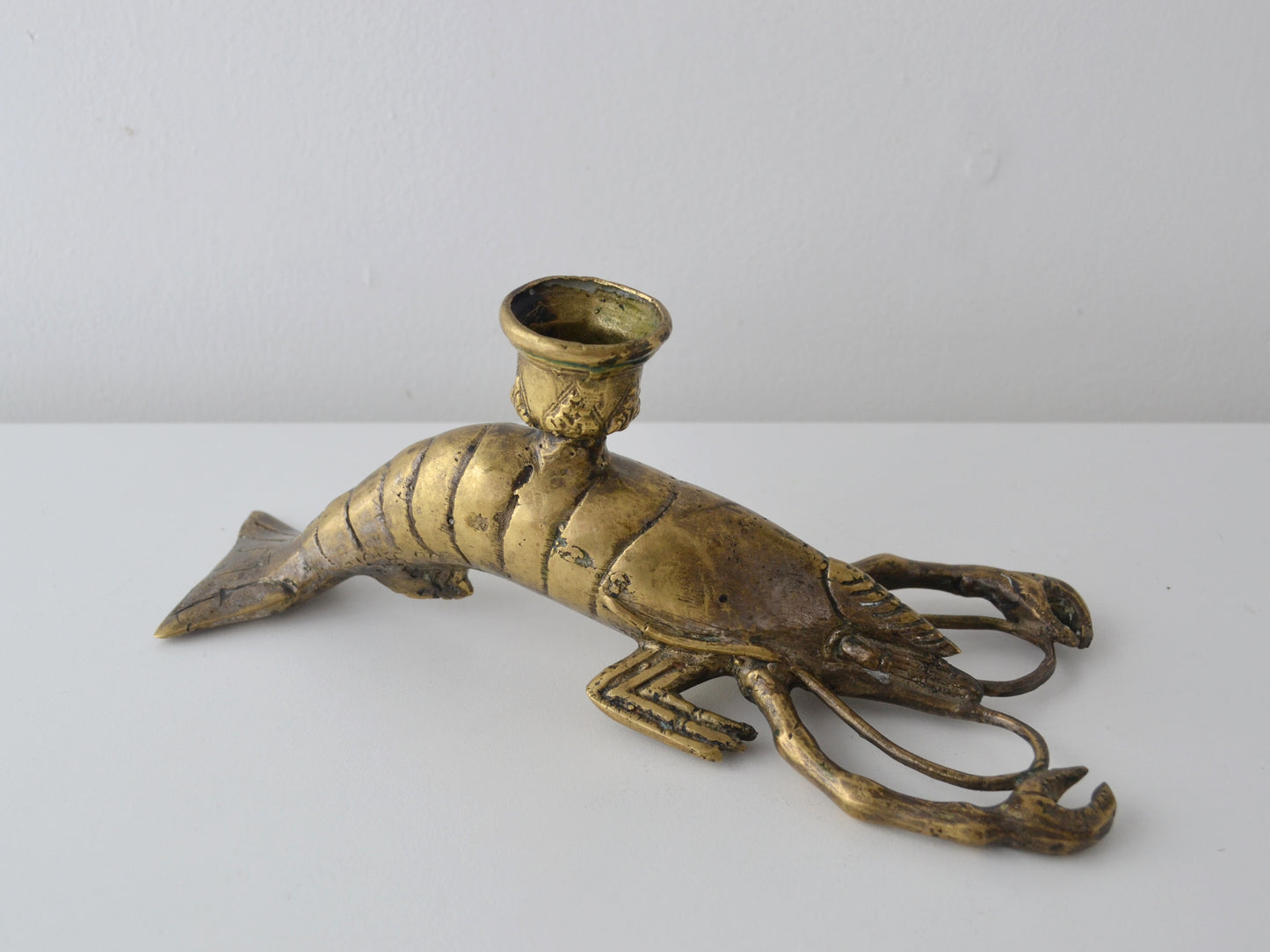 Cast brass lobster candlestick, Hollywood Regency figural, recumbent form with candle socket on back, circa 1960s, side view