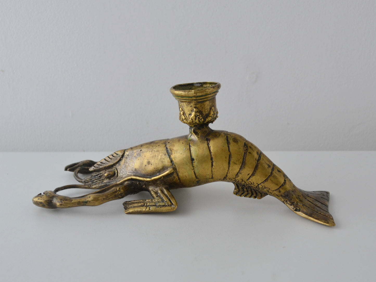Front view of cast brass lobster candlestick showing articulated claws and leg detail, Hollywood Regency, circa 1960s
