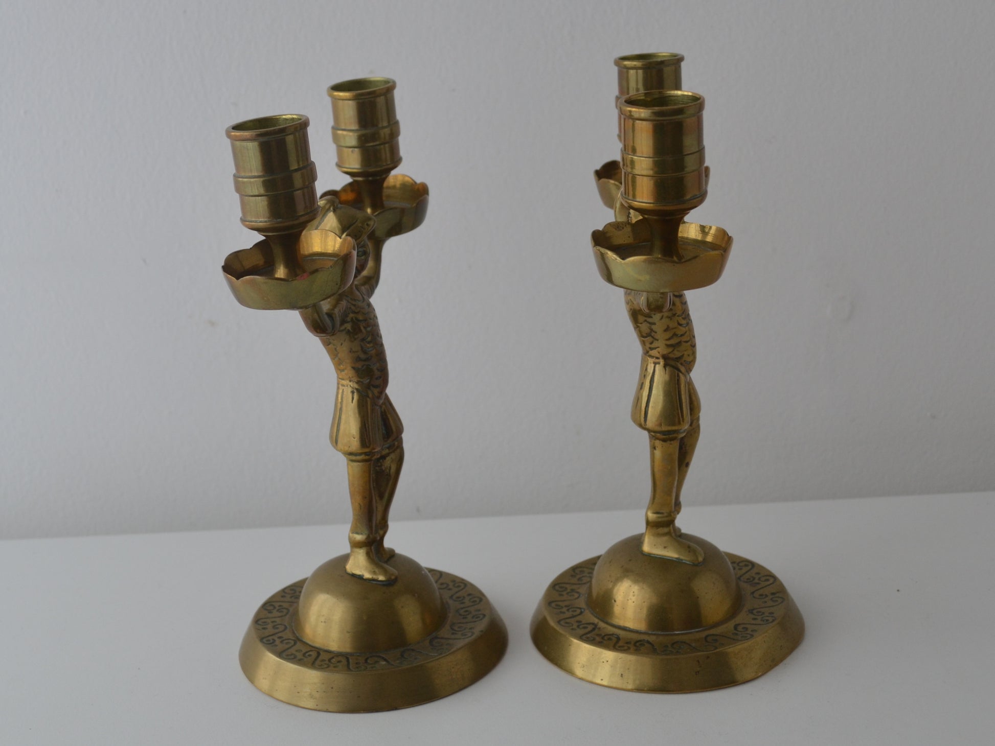 Cast brass Empire figural candelabra, armoured soldier with extended arms, domed engraved base, side view, circa 1900