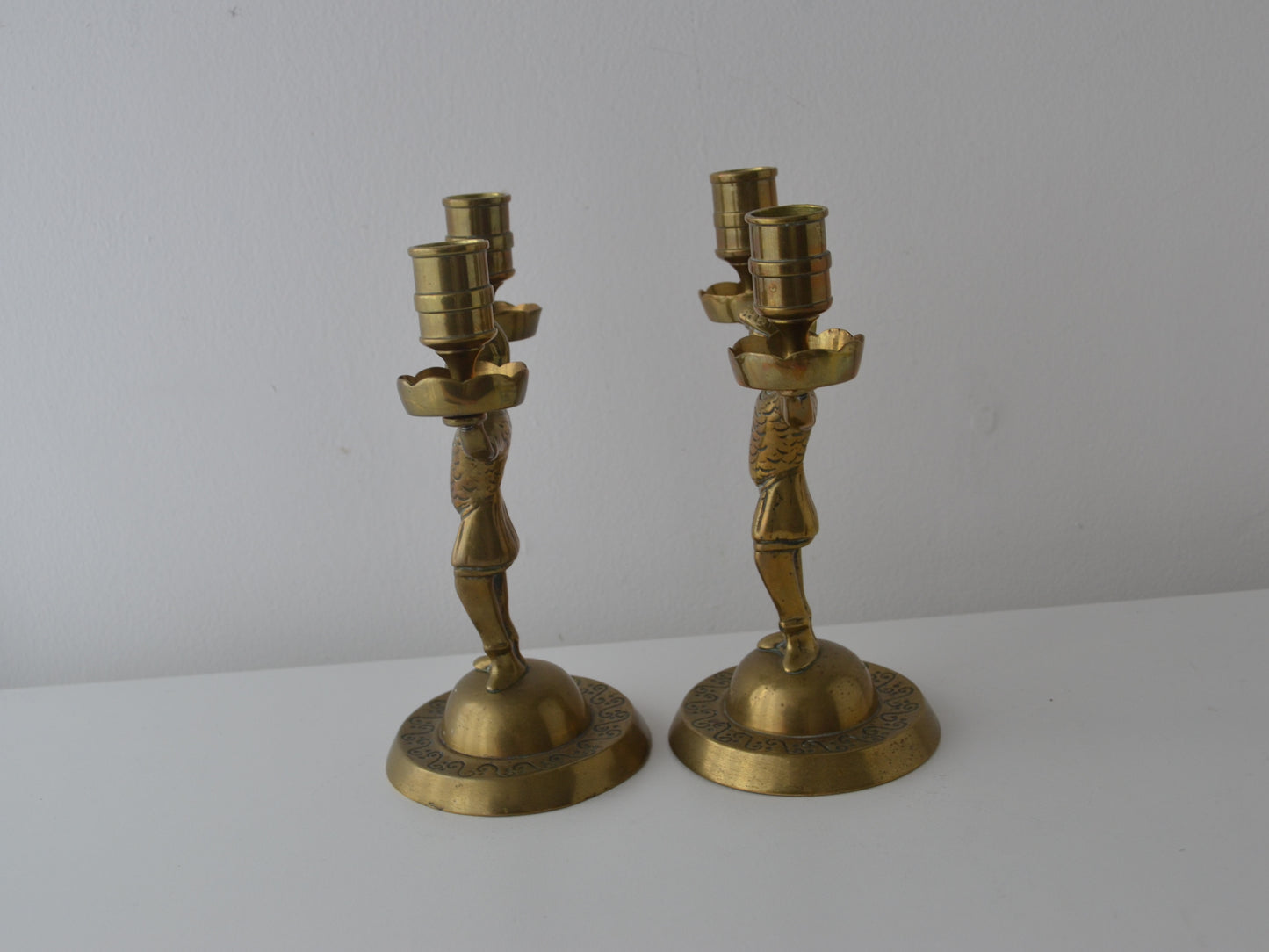 Cast brass Empire figural candelabra, armoured soldier stem with plumed helmet, scalloped drip pans, front view, circa 1900