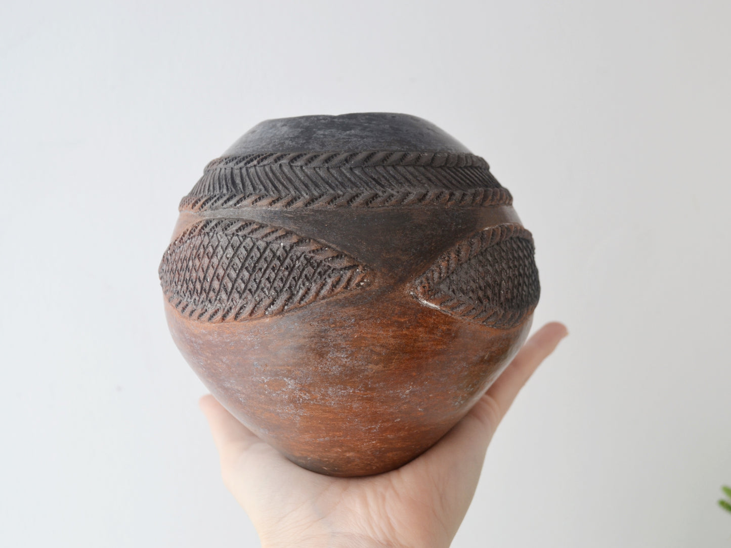 Close-up of incised geometric herringbone and diamond decoration on Zulu ukhamba by Mfeka, smoke-fired earthenware