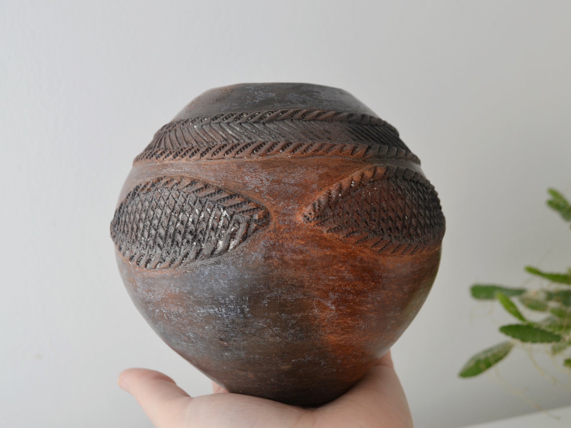 moke-fired ombre surface detail of Zulu ukhamba by Mfeka, natural terracotta and charcoal tones, KwaZulu-Natal