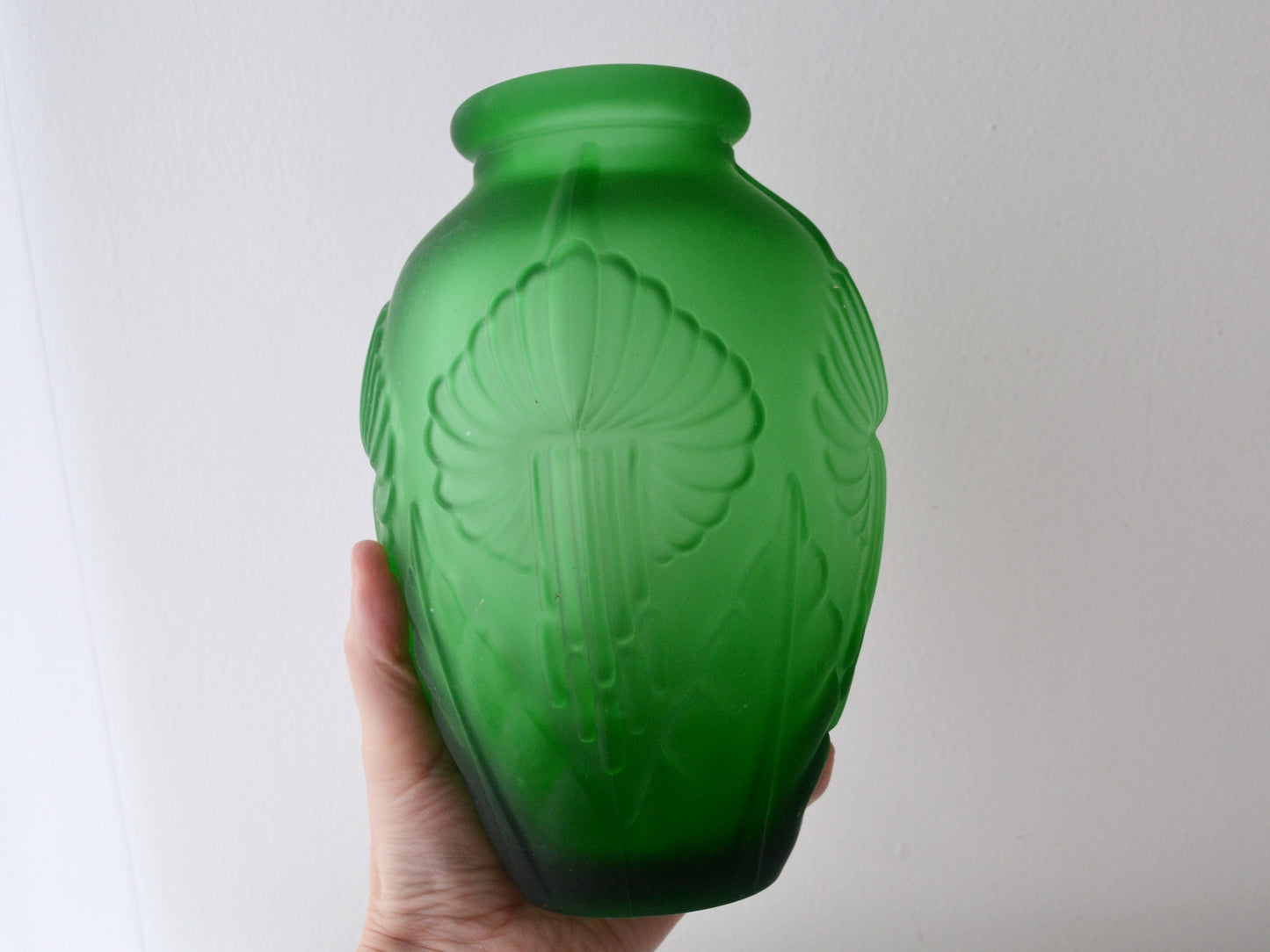 Stylised calla lily relief detail on green satin Art Deco glass vase, circa 1920s.