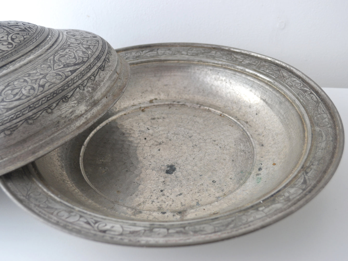 Persian tinned copper serving dish base without cover, showing engraved rim border and lathe-turned interior, circa late 19th century
