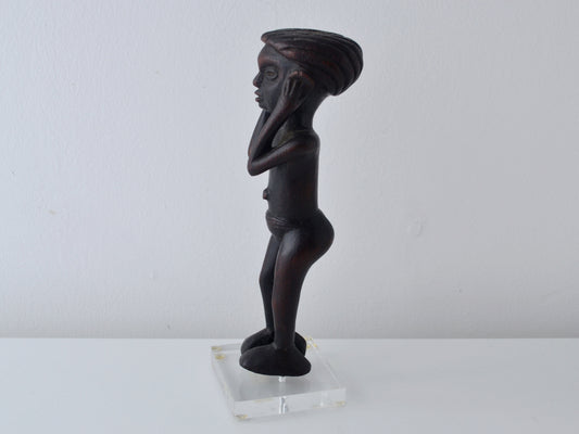 East African Makonde carved hardwood youth figure, side view showing elongated form and raised arms, Tanzania circa 1960s