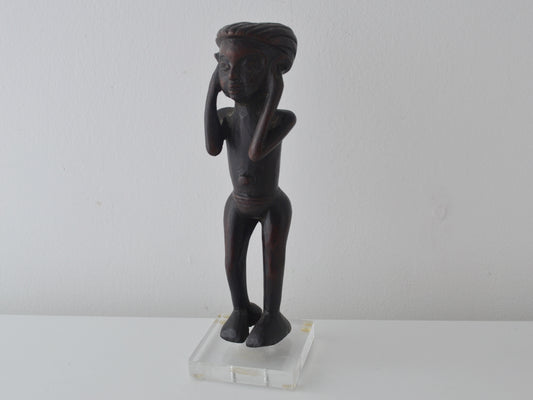 East African carved hardwood figure of a standing youth, Makonde tradition Tanzania circa mid-20th century, on gallery lucite base, front view