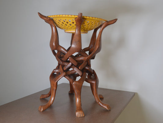 Hand-carved hardwood dog figures stand with Moroccan ceramic bowl, folk art, circa 1960s, front view