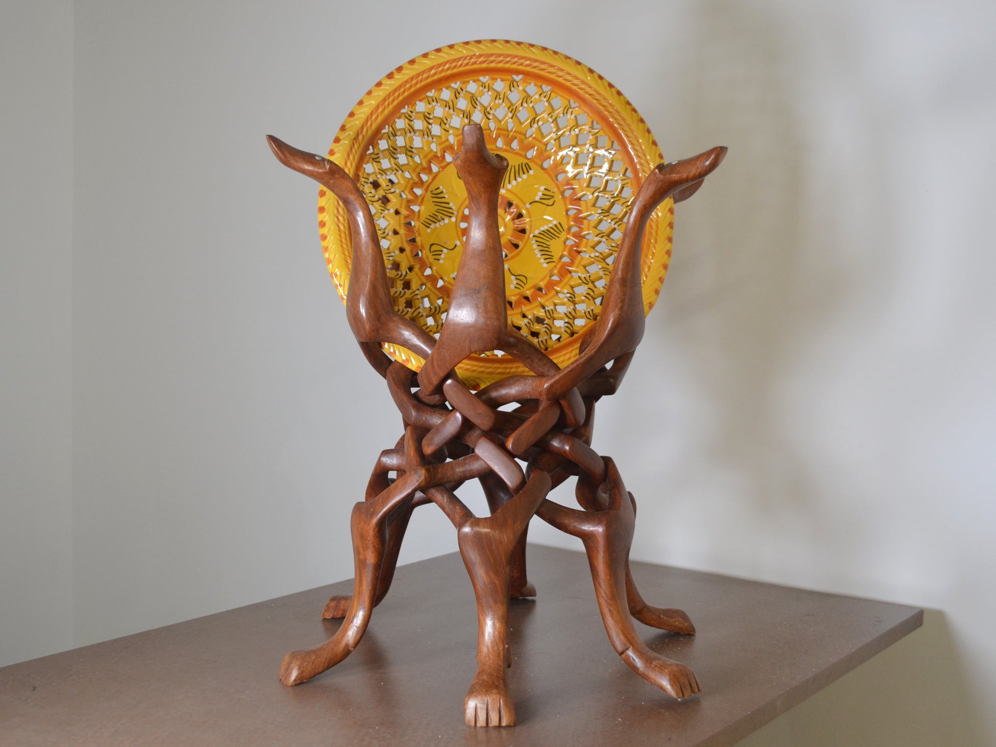 Wood grain detail of dense tropical hardwood dog figures stand, circa 1960s.