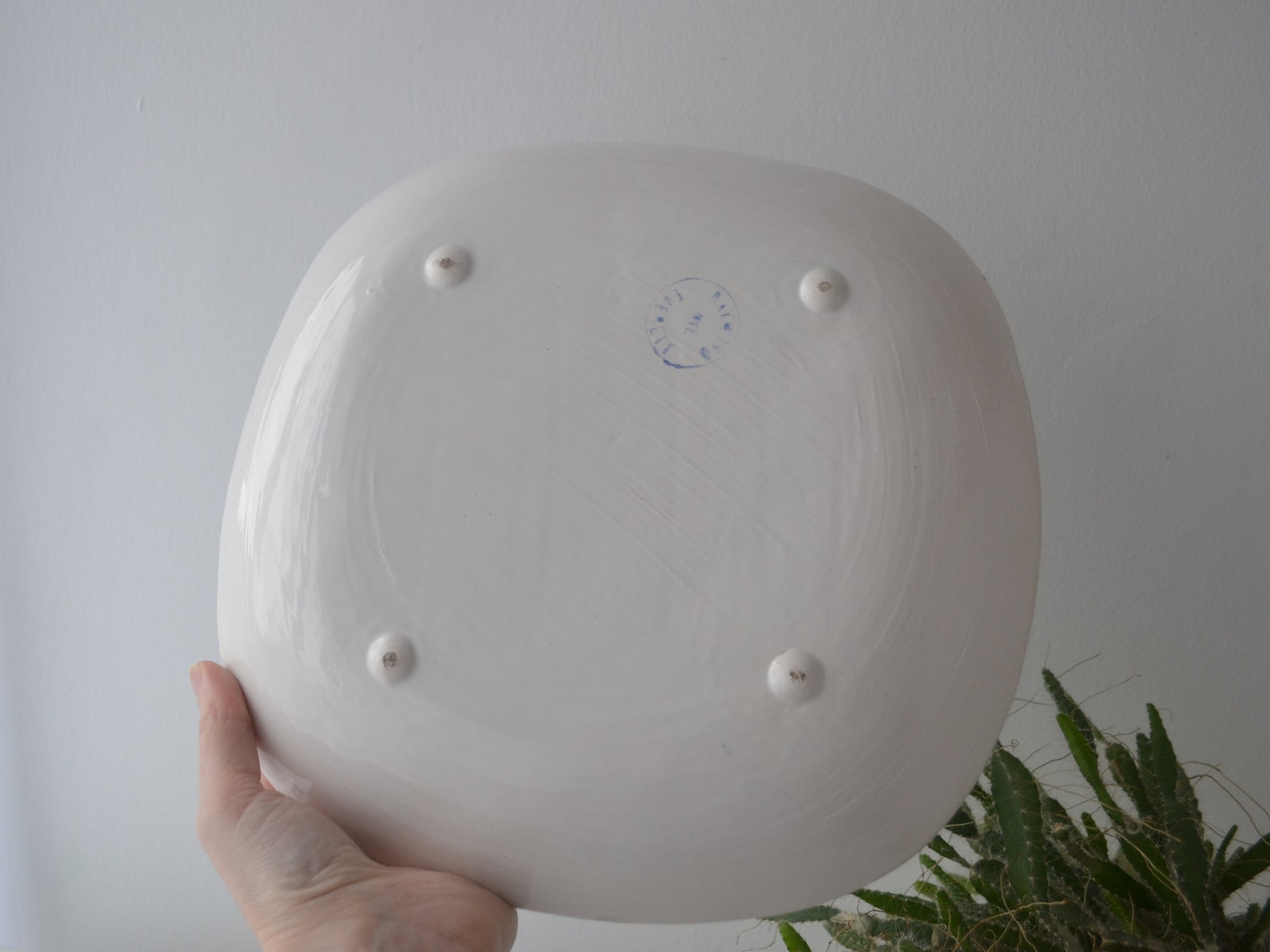 Close-up of Rye Pottery blue printed circular mark on reverse of sgraffito plate, circa 1950s