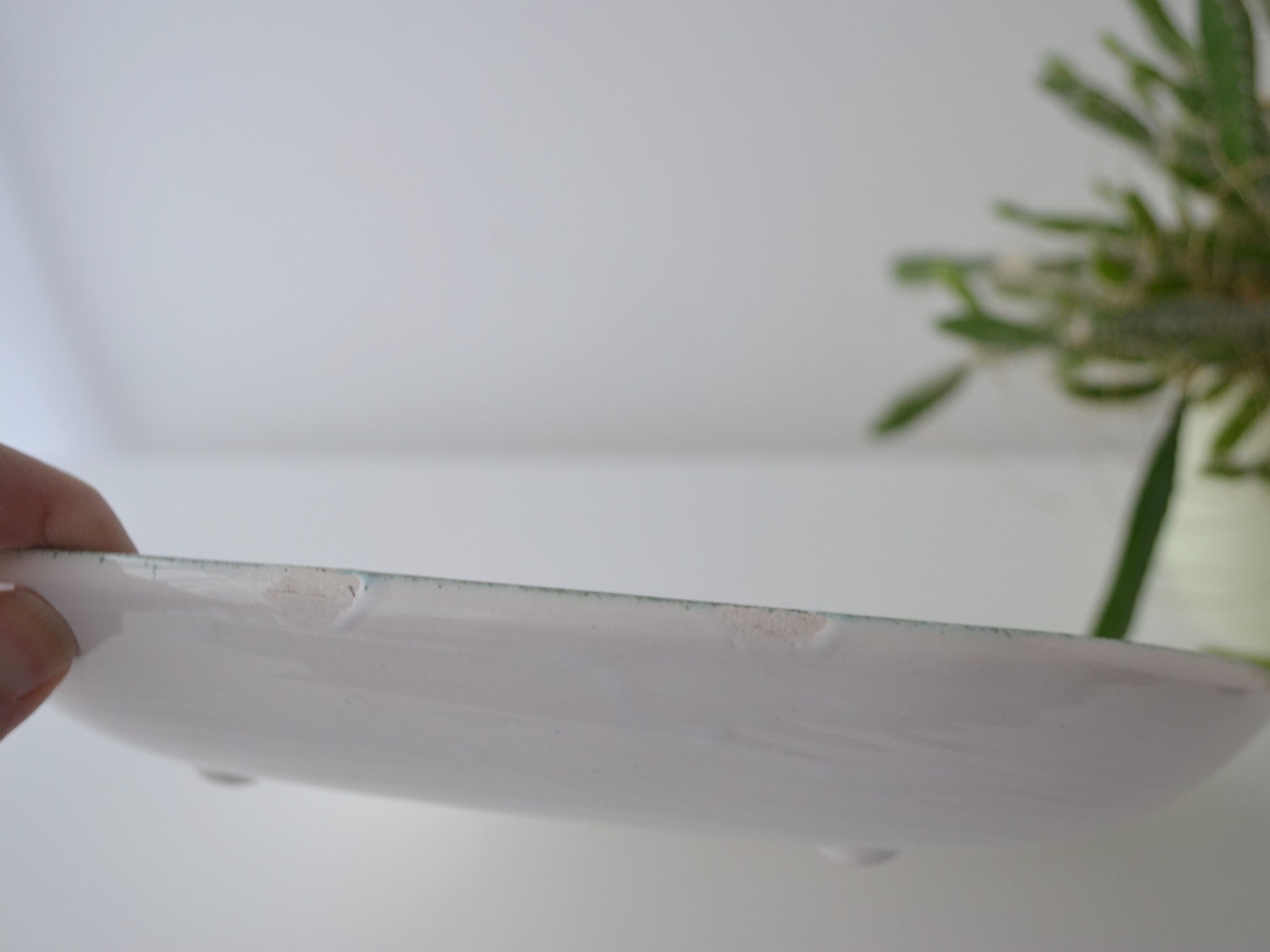 Reverse of Rye Pottery sgraffito plate showing Finger print glaze, four feet and blue printed pottery mark, circa 1950s