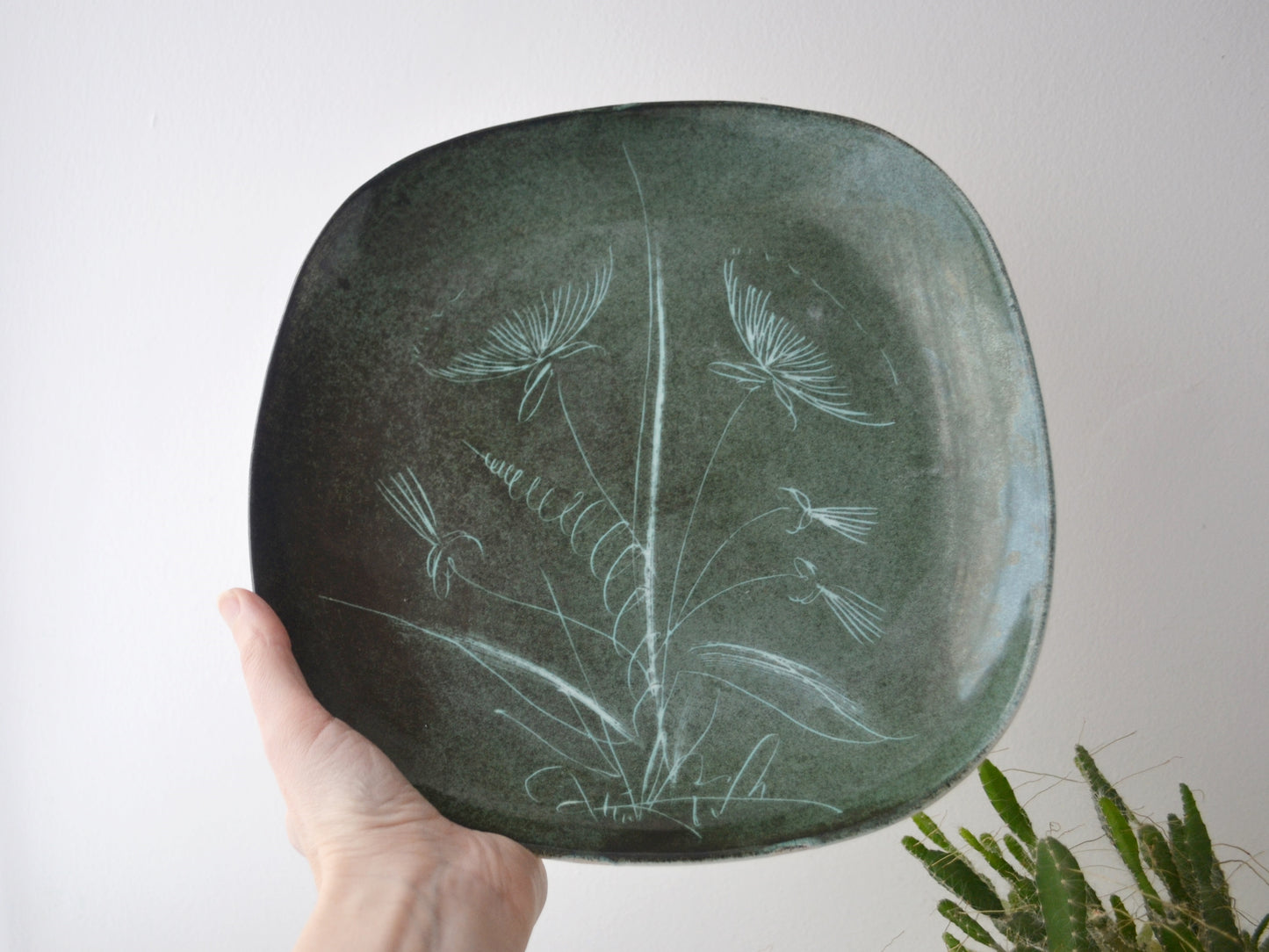 Rye Pottery sgraffito plate, deep green glaze, botanical dandelion motif, hand-incised, 28cm, circa 1950s, front view